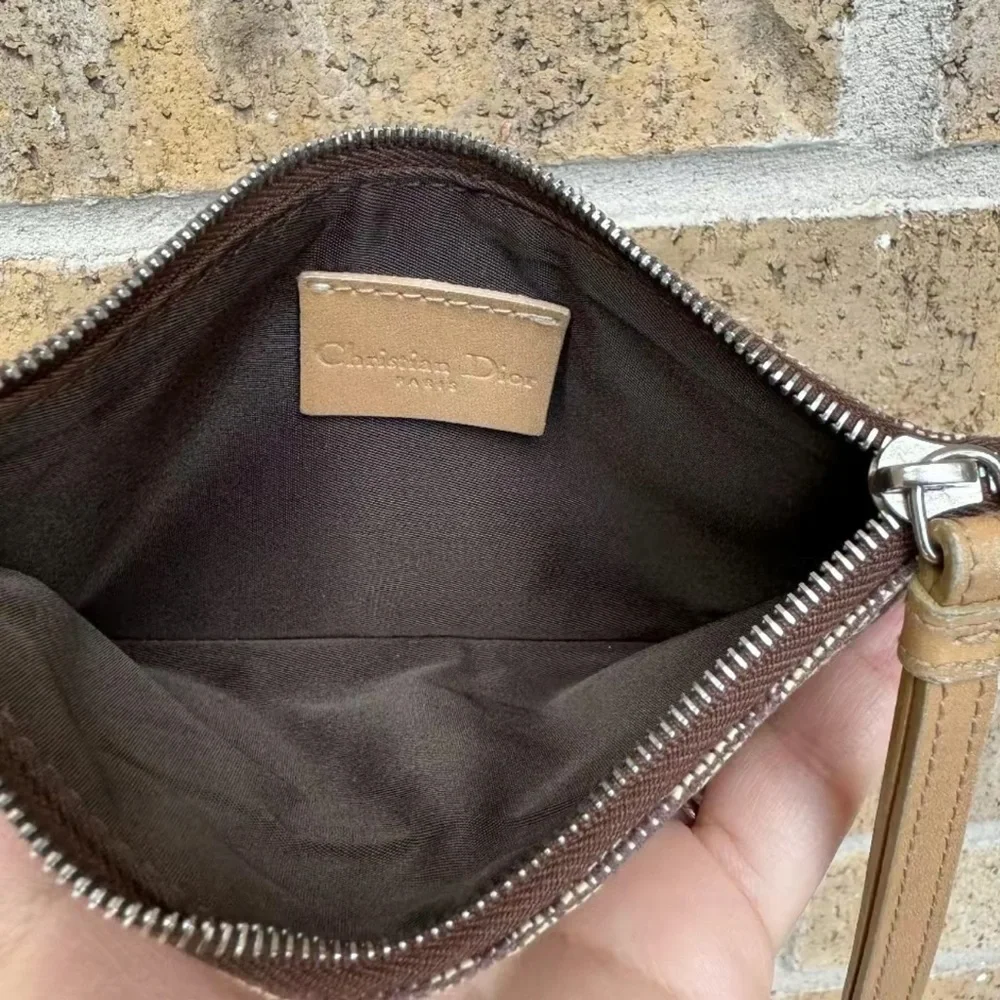 Christian Dior monogram wristlet. Comes with copy of COA from Entrupy